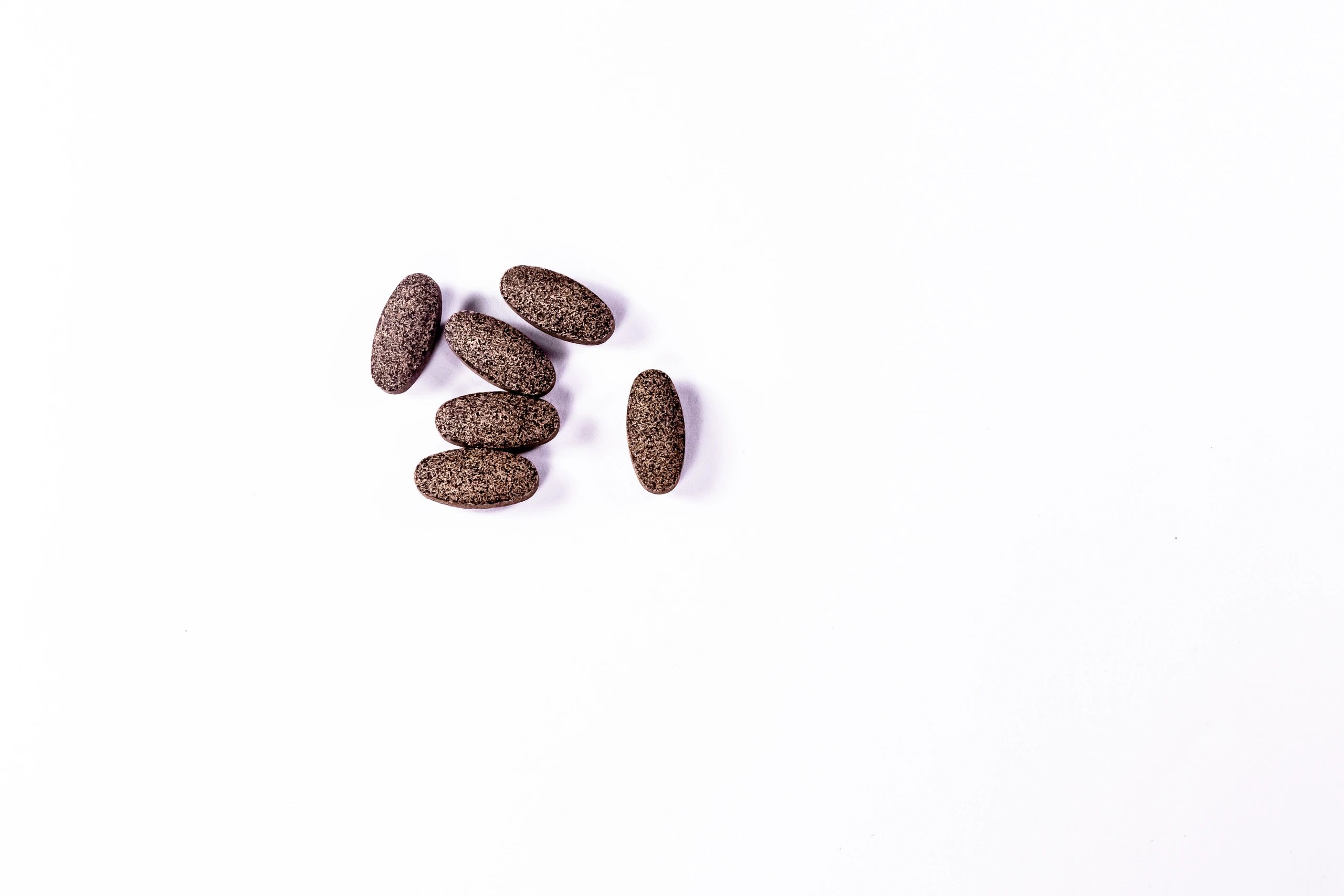 Minimal supplement capsules on a white background