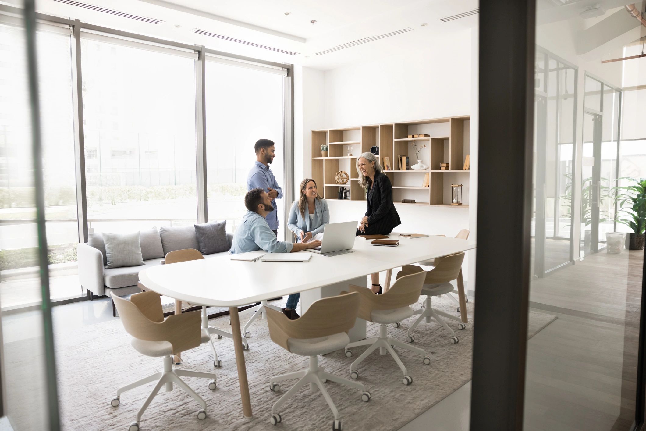 Small team meeting around a table in a modern office