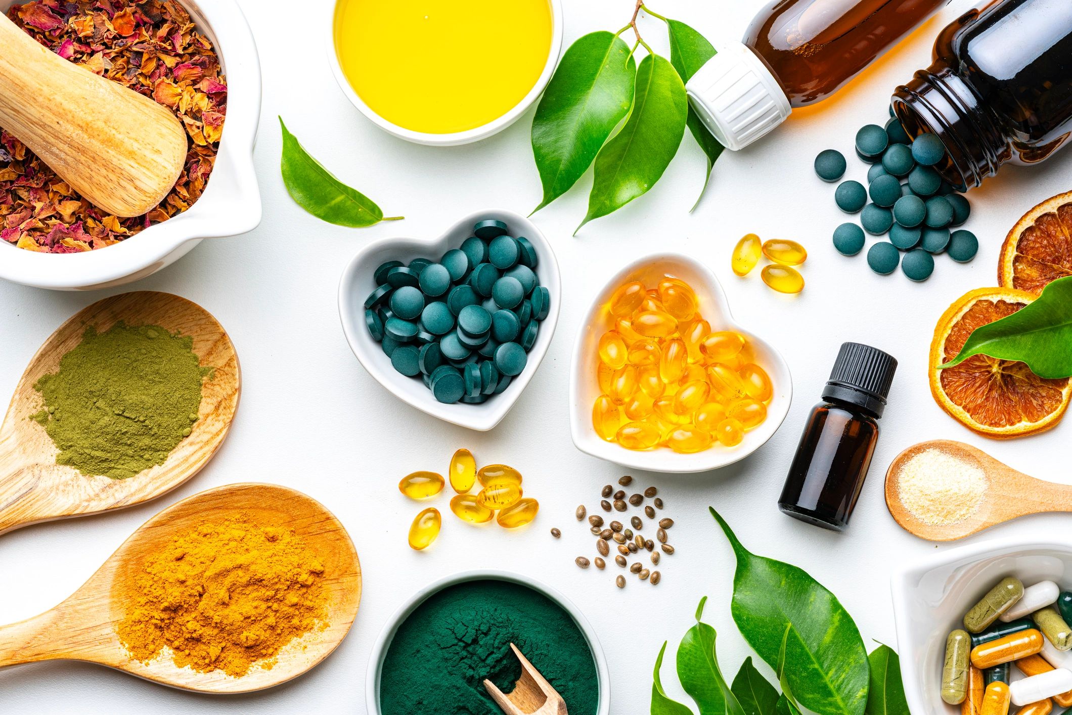 Assorted vitamins and supplements arranged on a white background