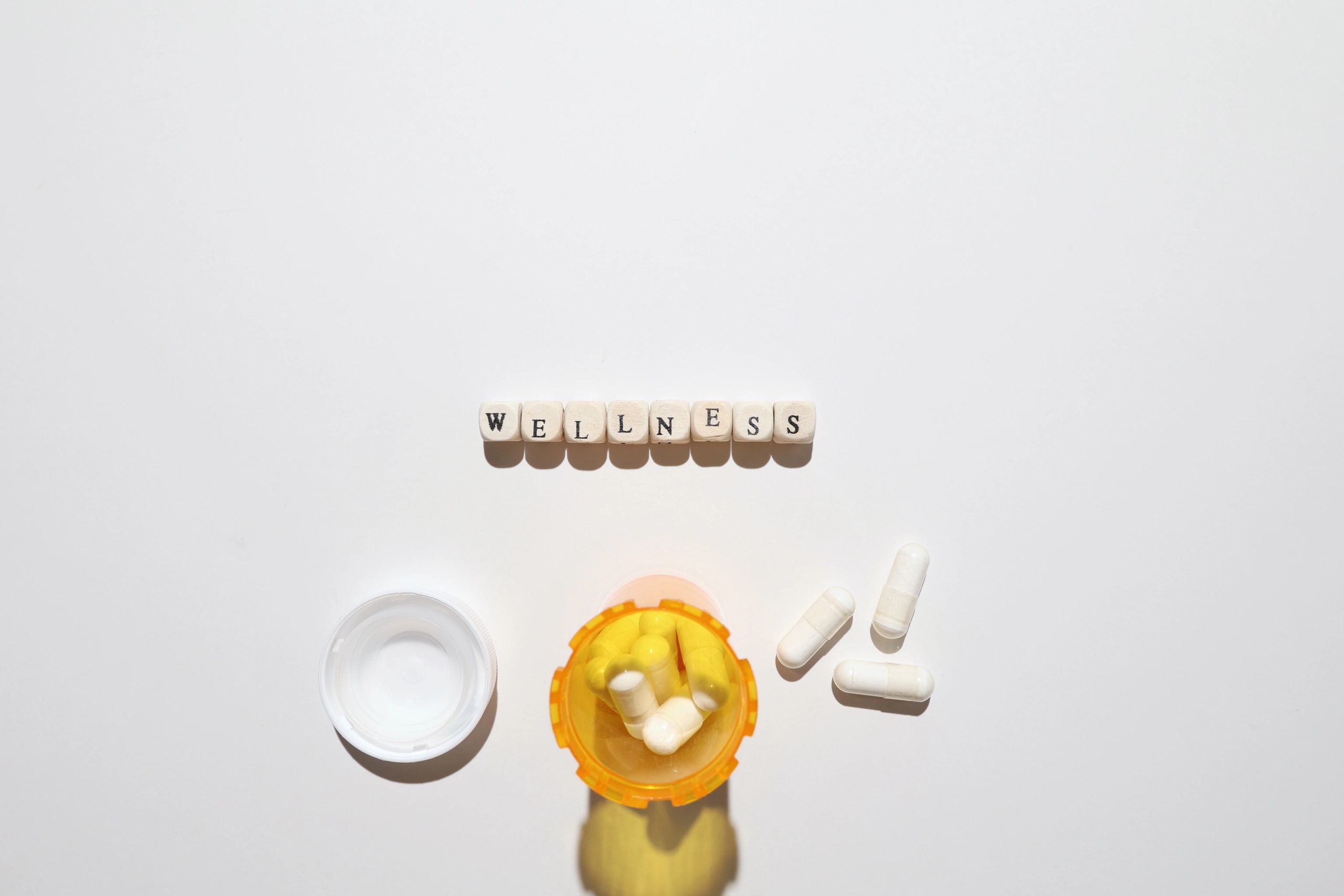 Wellness capsules and bottle on a clean white background